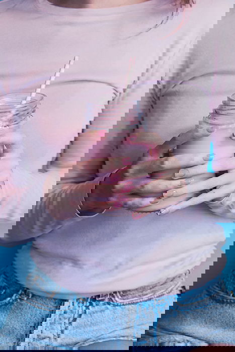 cool nail photography of a female model with pink painted nails